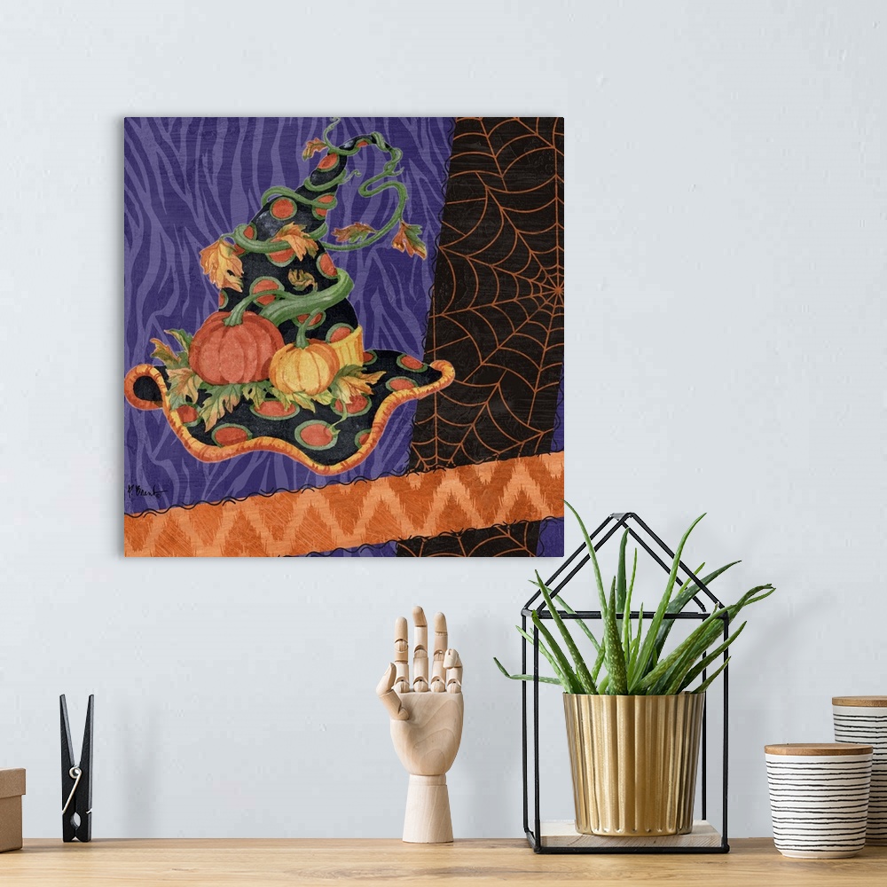 A bohemian room featuring Halloween themed artwork of a witch's pointy hat in festive purple and orange patterns.