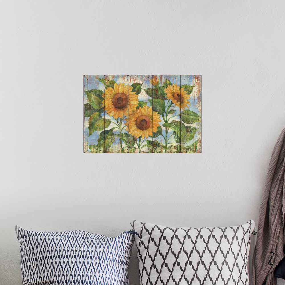 A bohemian room featuring Contemporary decorative artwork of three large sunflowers in full bloom on a textured panel backg...