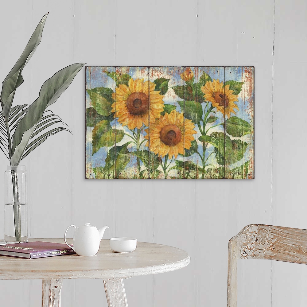 A farmhouse room featuring Contemporary decorative artwork of three large sunflowers in full bloom on a textured panel backg...