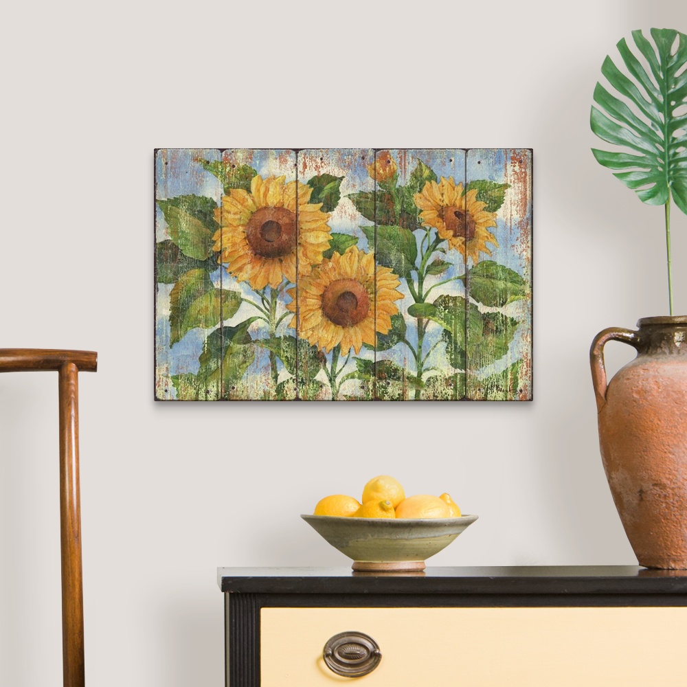 A traditional room featuring Contemporary decorative artwork of three large sunflowers in full bloom on a textured panel backg...