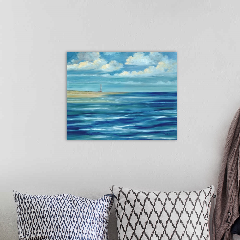 A bohemian room featuring Contemporary artwork of a lighthouse on the coast, seen across the ocean under a cloudy sky.
