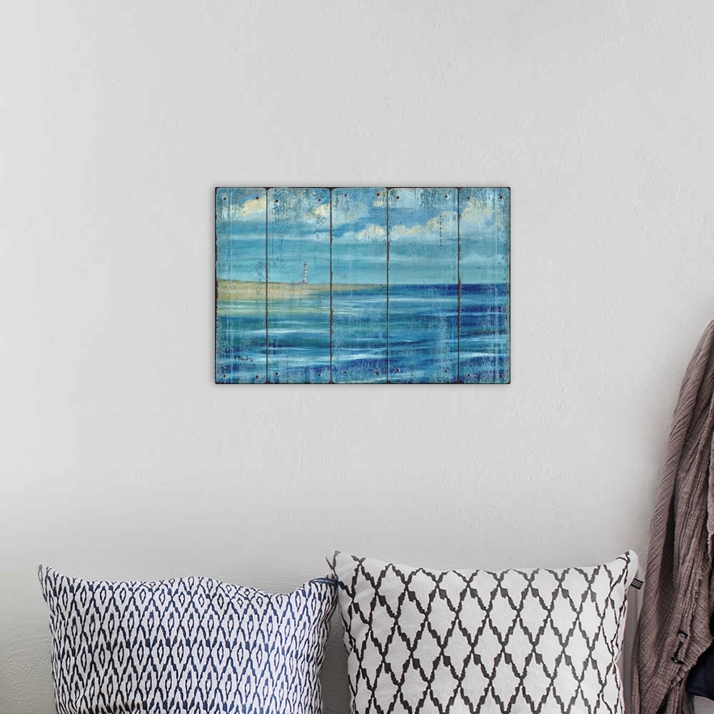 A bohemian room featuring Contemporary artwork of a lighthouse on the coast, seen across the ocean under a cloudy sky on a ...