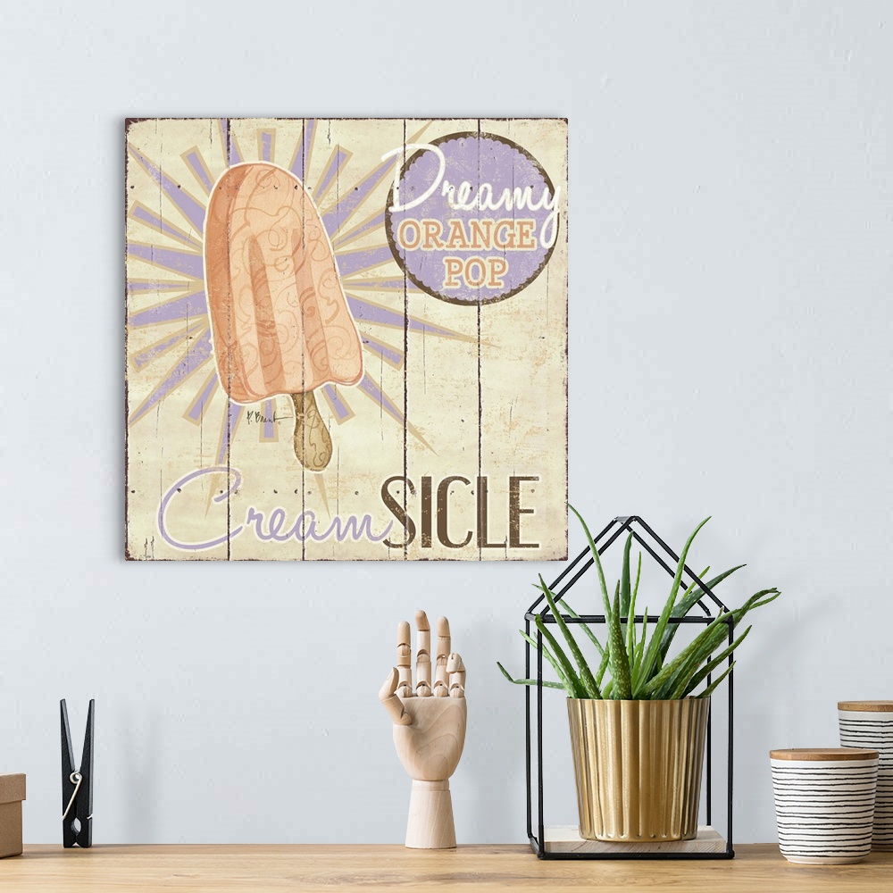 A bohemian room featuring A vintage ice cream shop sign featuring an orange creamsicle.