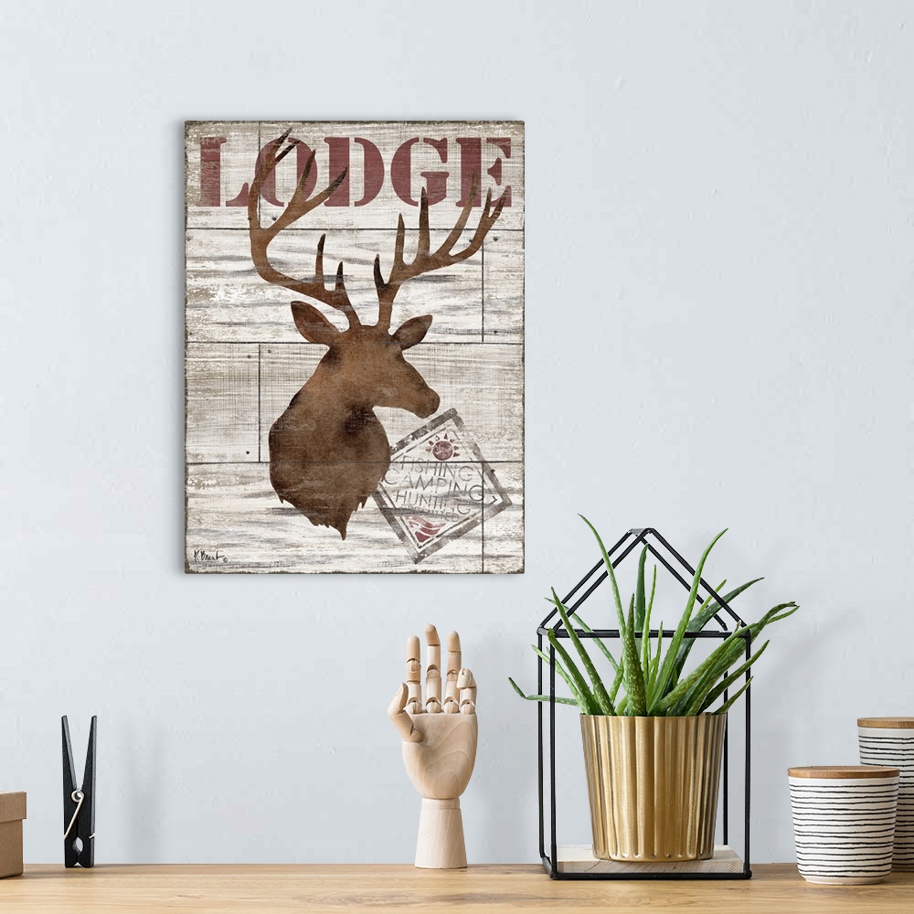 A bohemian room featuring Contemporary decorative artwork of a deer silhouette with the word "lodge" on a textured wooden b...