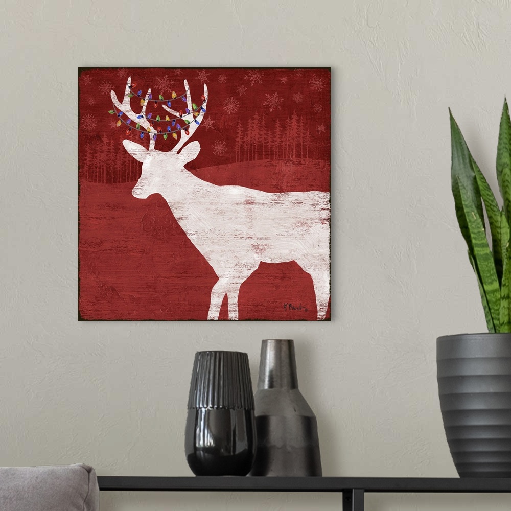 A modern room featuring White silhouette of a deer with lights in its antlers on a red forest backdrop.
