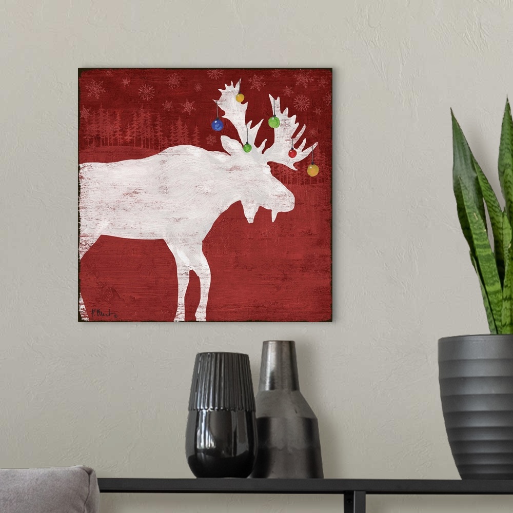 A modern room featuring White silhouette of a moose with ornaments on its antlers on a red forest backdrop.