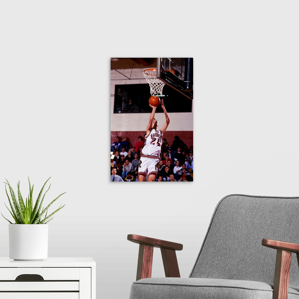 A modern room featuring Boys High School basketball player going up for a shot