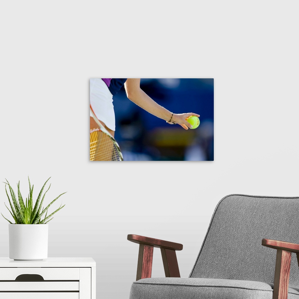 A modern room featuring Detail of woman serving during tennis match
