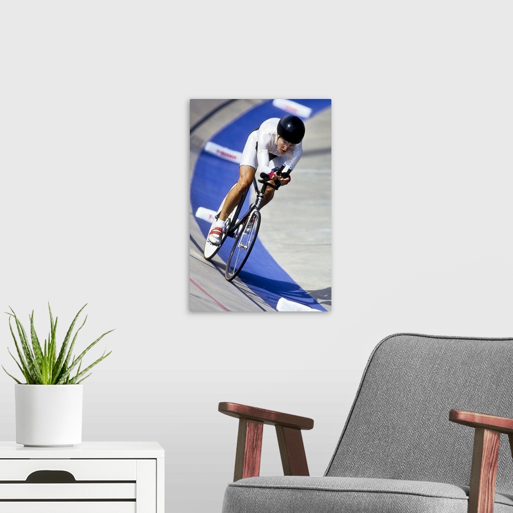 A modern room featuring Female cyclist racing on the velodrome track