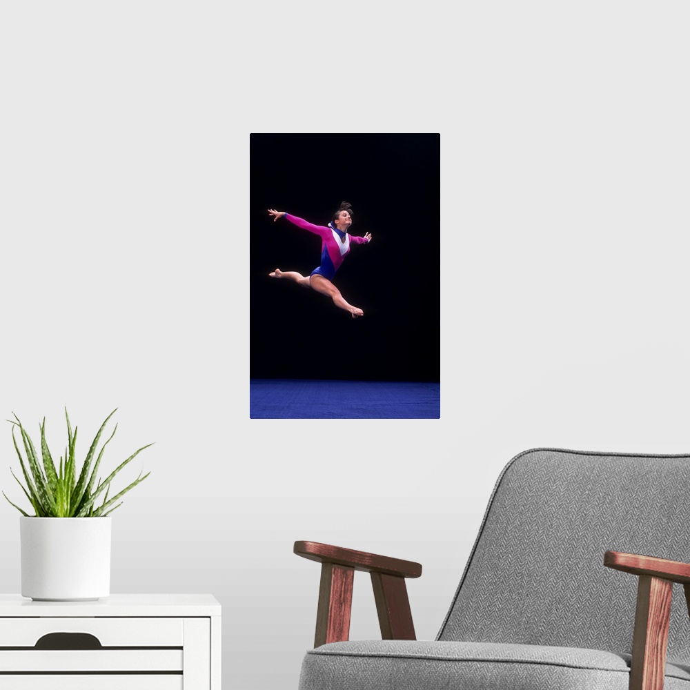 A modern room featuring Female gymnast on the floor exercise