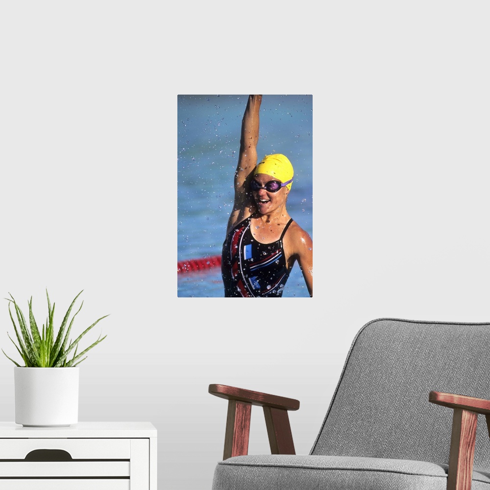 A modern room featuring Female swimmer reacts to victory