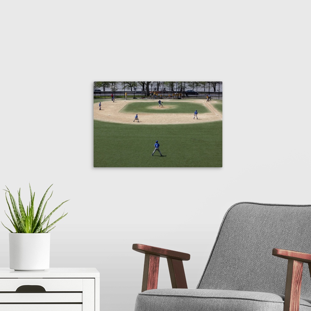 A modern room featuring Little league baseball field with game in progress