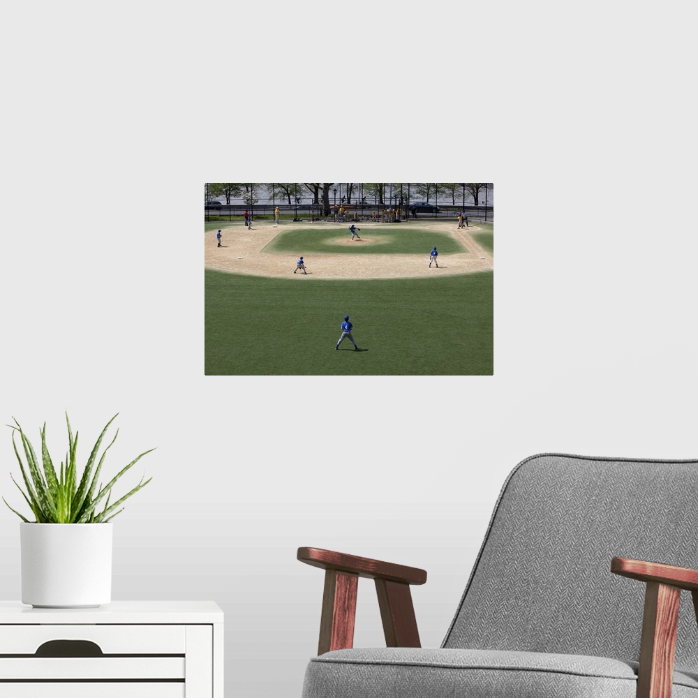 A modern room featuring Little league baseball field with game in progress