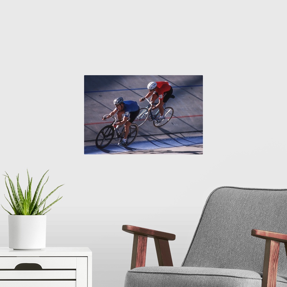 A modern room featuring Male cyclists competing on the velodrome