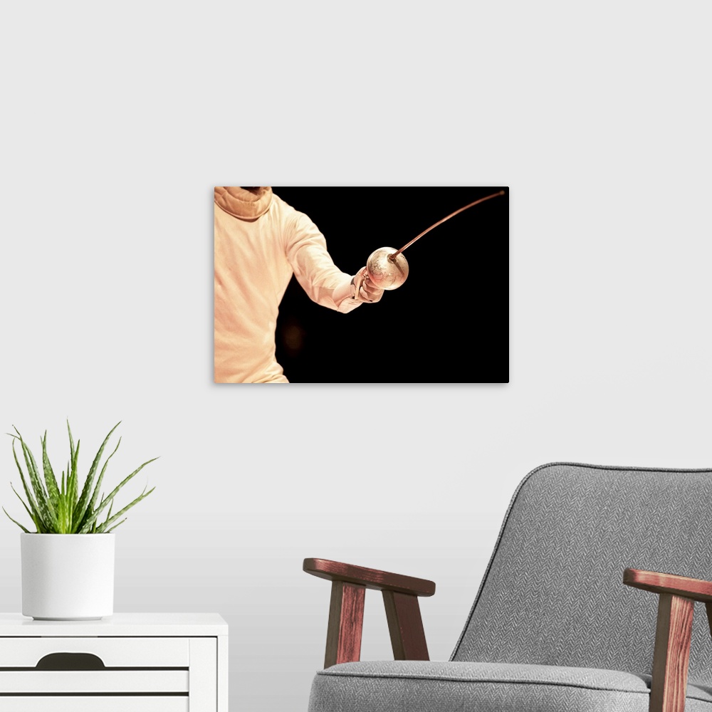 A modern room featuring Male fencer in action