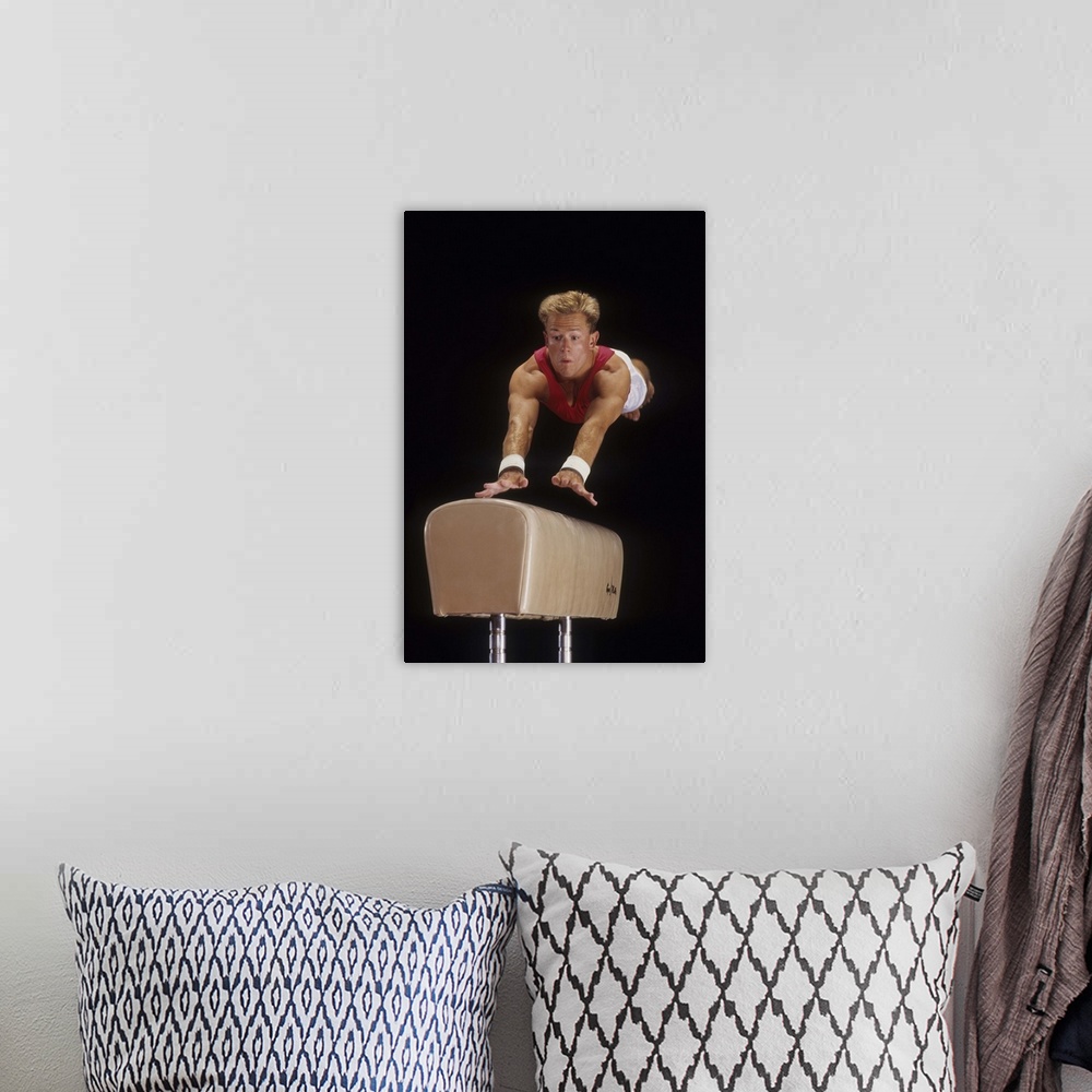 A bohemian room featuring Male gymnast on the vault