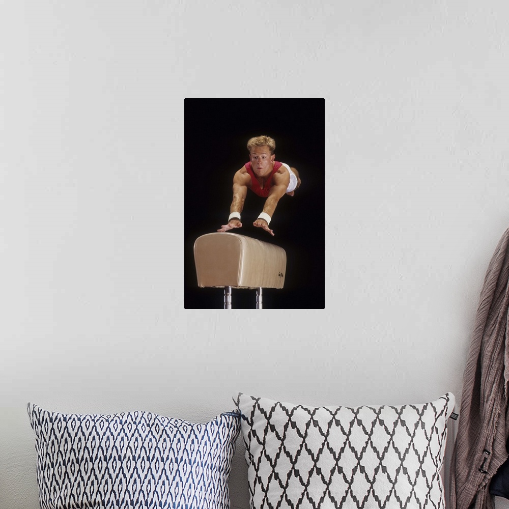 A bohemian room featuring Male gymnast on the vault