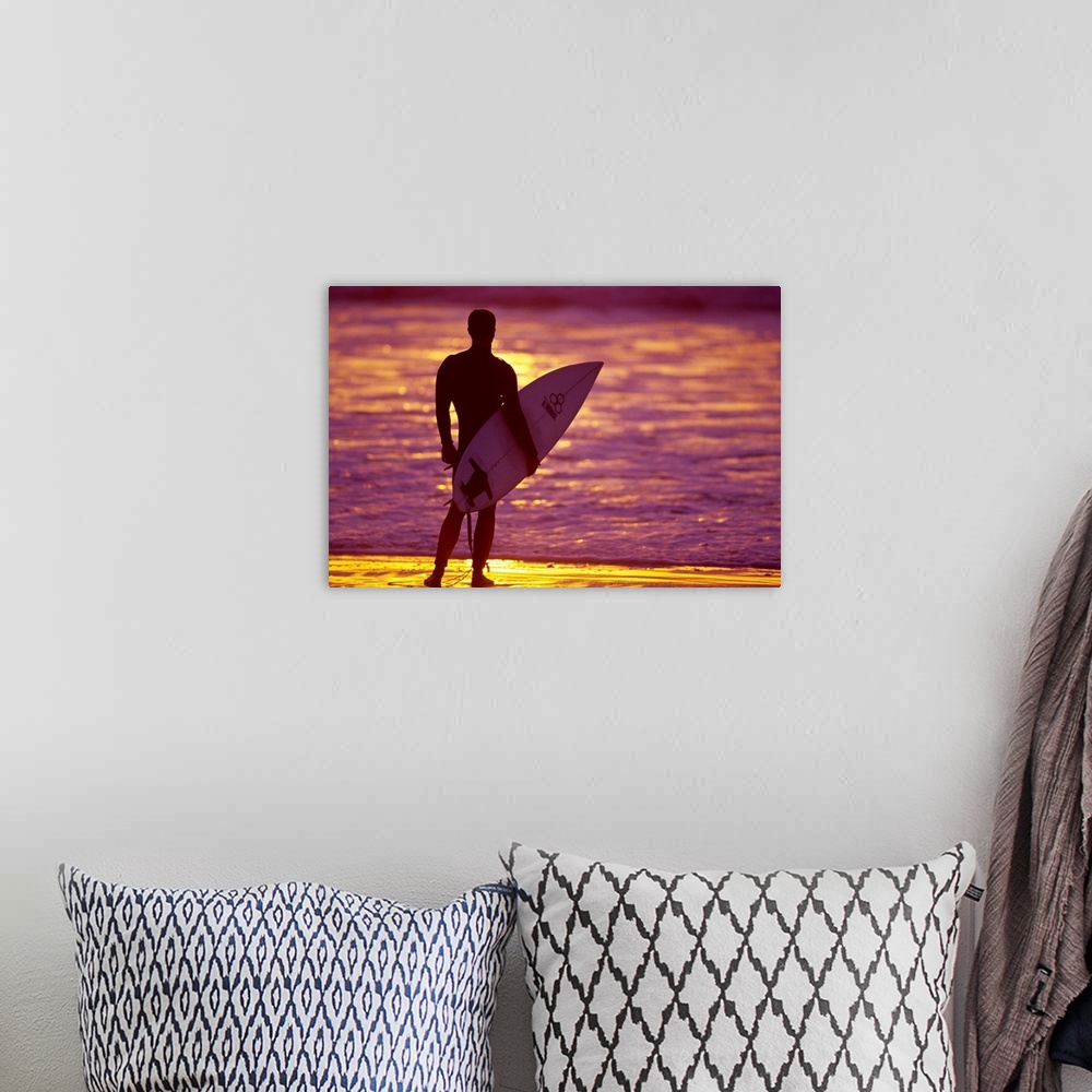 A bohemian room featuring Male surfer on the beach in San Diego, CA