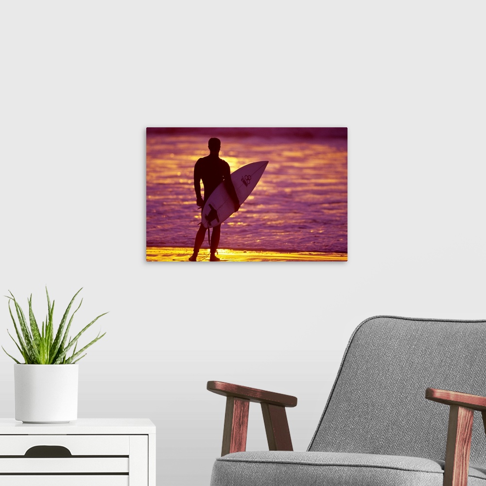A modern room featuring Male surfer on the beach in San Diego, CA