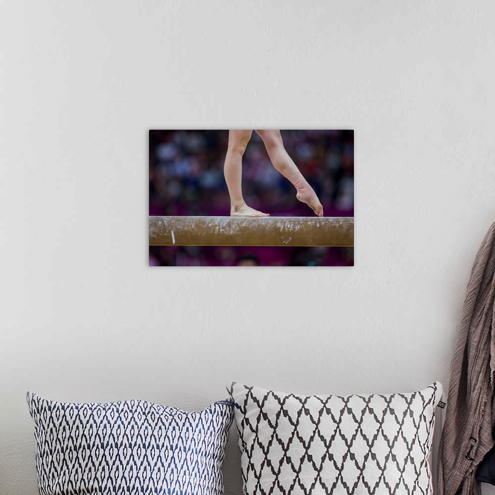 A bohemian room featuring Detail of gymnast  preforming on the balance beam during the women's gymnastics team finals at th...