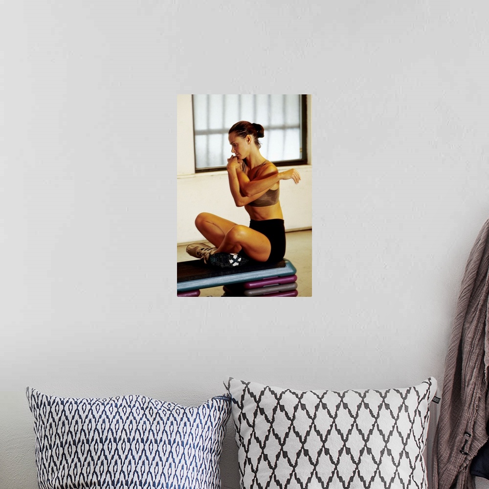 A bohemian room featuring Woman stretching during working out