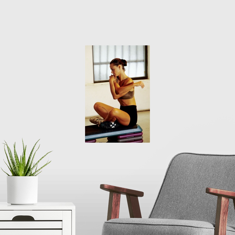 A modern room featuring Woman stretching during working out