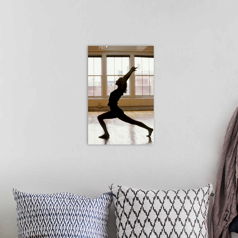 A bohemian room featuring Young woman in yoga position