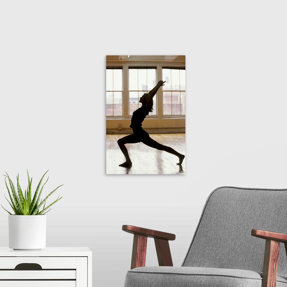 A modern room featuring Young woman in yoga position