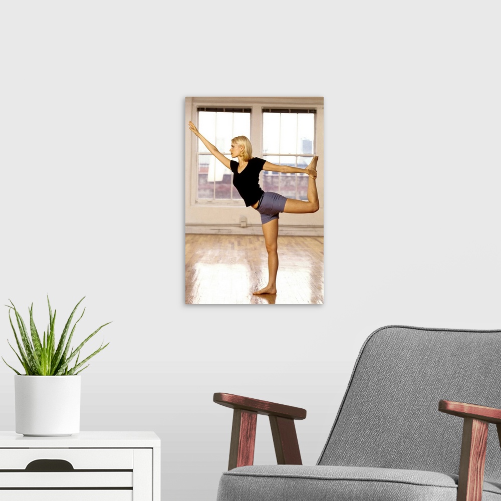 A modern room featuring Young woman in yoga position