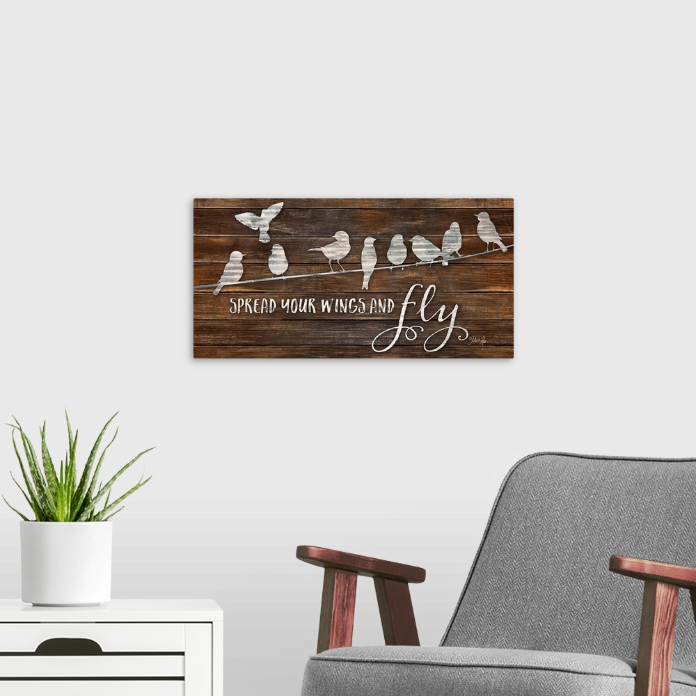 A modern room featuring "Spread Your Wings and Fly" with a design of birds on a line on a brown wood plank background.