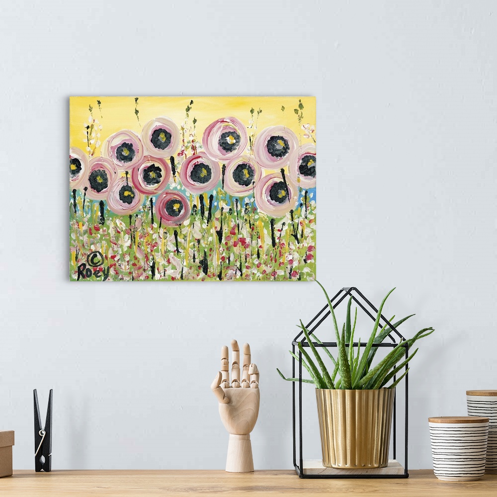 A bohemian room featuring Horizontal abstract painting of a field of flowers in textured colors of pink, green and yellow.