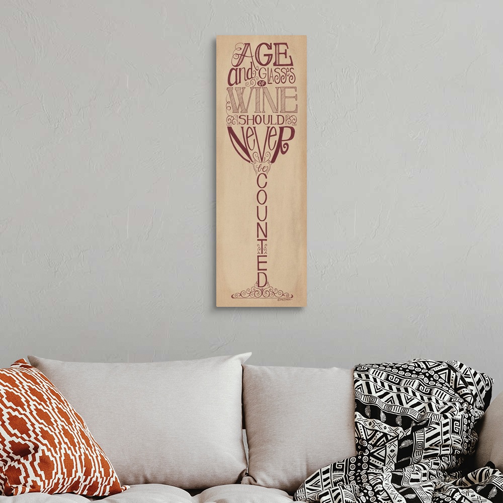 A bohemian room featuring Handlettered home decor art with dark red lettering against a distressed brown background.