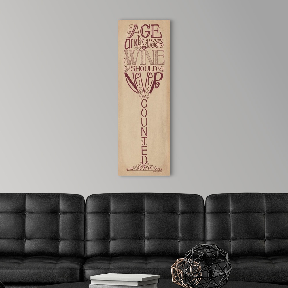 A modern room featuring Handlettered home decor art with dark red lettering against a distressed brown background.