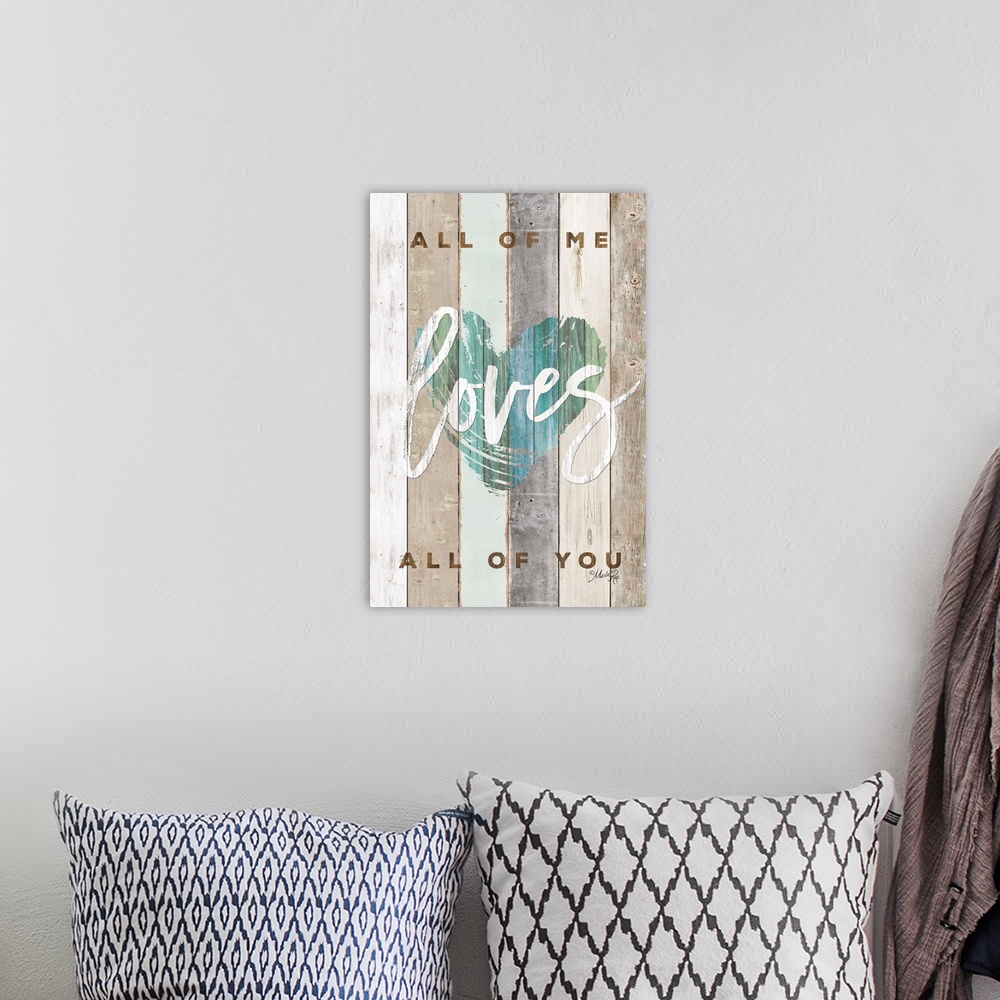 A bohemian room featuring "All of Me Loves All of You" with a blue/green heart design on wood plank background.