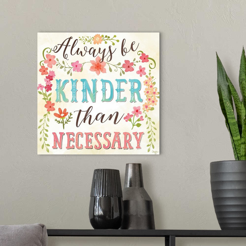 A modern room featuring Brightly colored hand-lettered typography art framed with flowers and leaves.