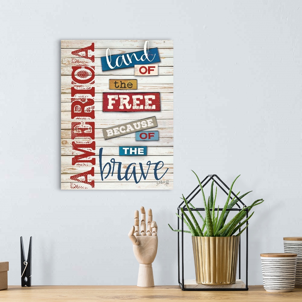 A bohemian room featuring Patriotic typography art in red white and blue against white distressed wooden boards.