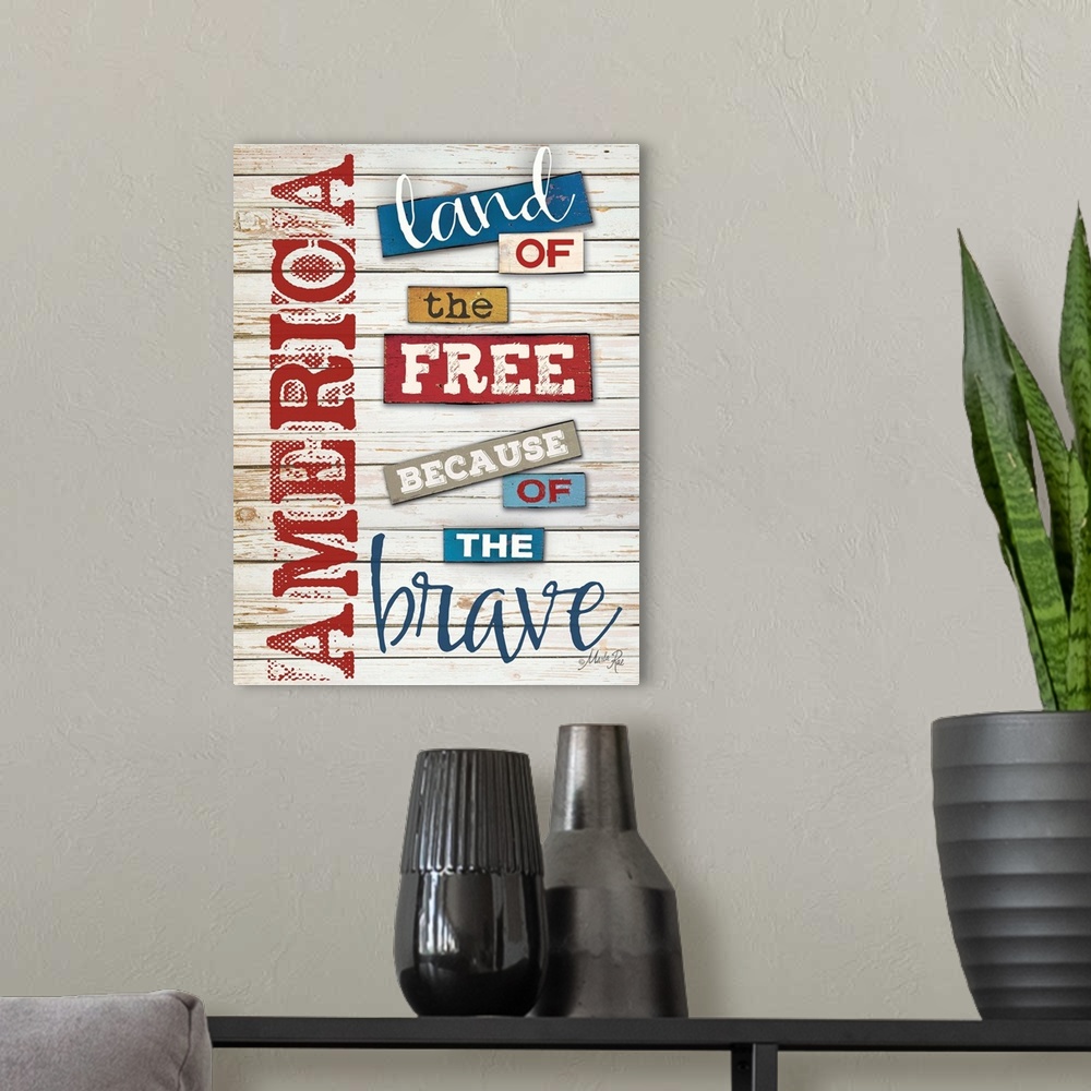 A modern room featuring Patriotic typography art in red white and blue against white distressed wooden boards.
