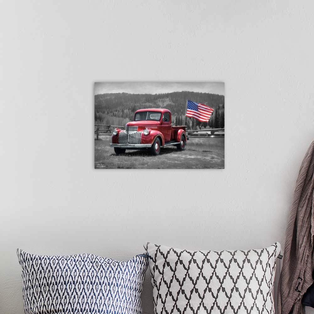 A bohemian room featuring A vintage red truck with an American Flag in a field in the countryside.