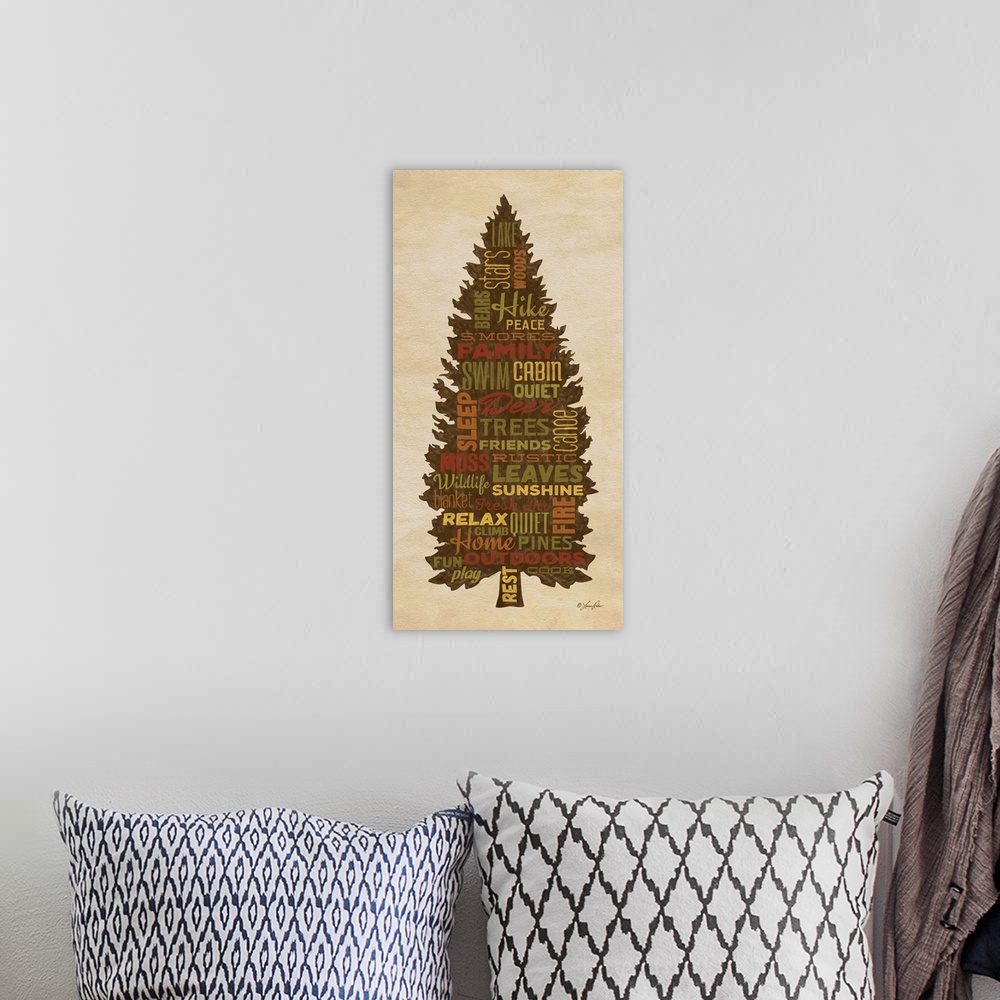 A bohemian room featuring Typography art of forest and lake lodge-themed words in the silhouette of a pine tree.