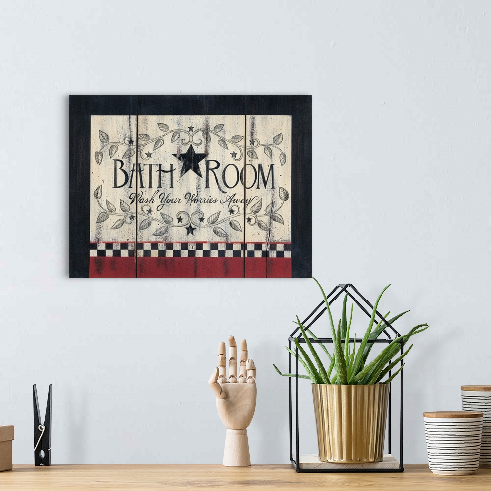 A bohemian room featuring Decorative artwork featuring the words: Bathroom, wash your worries away, in a rustic country style.