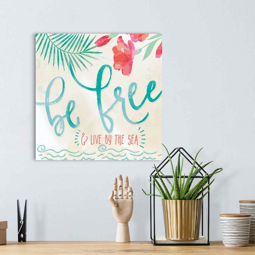 A bohemian room featuring Beach-themed artwork with "Be Free" in large script with a motif of tropical leaves and flowers.