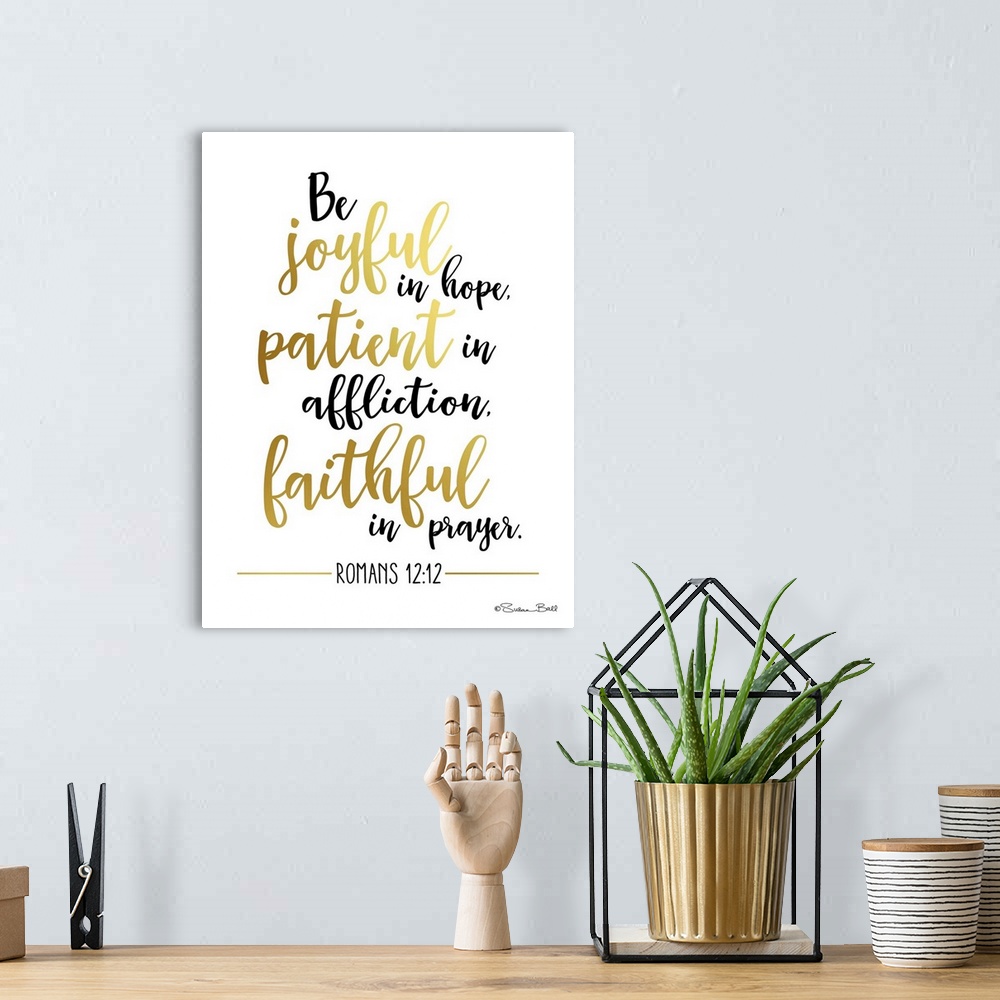 A bohemian room featuring Bible verse Romans 12:12 in black and gold script on white.