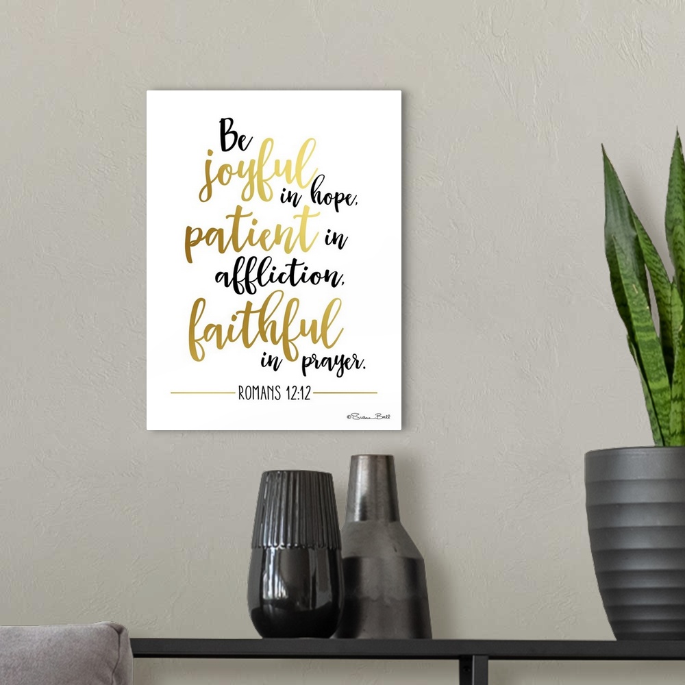 A modern room featuring Bible verse Romans 12:12 in black and gold script on white.