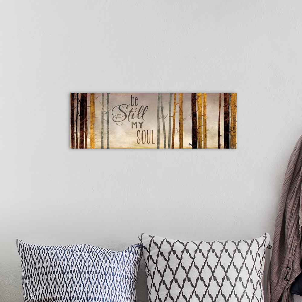 A bohemian room featuring Contemporary artwork of a forest with the words "Be still my soul."