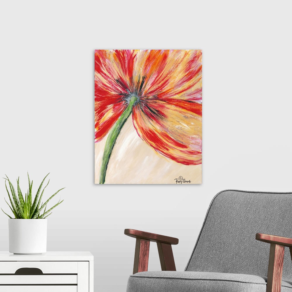 A modern room featuring Vertical close up of a vibrant red and yellow flower.