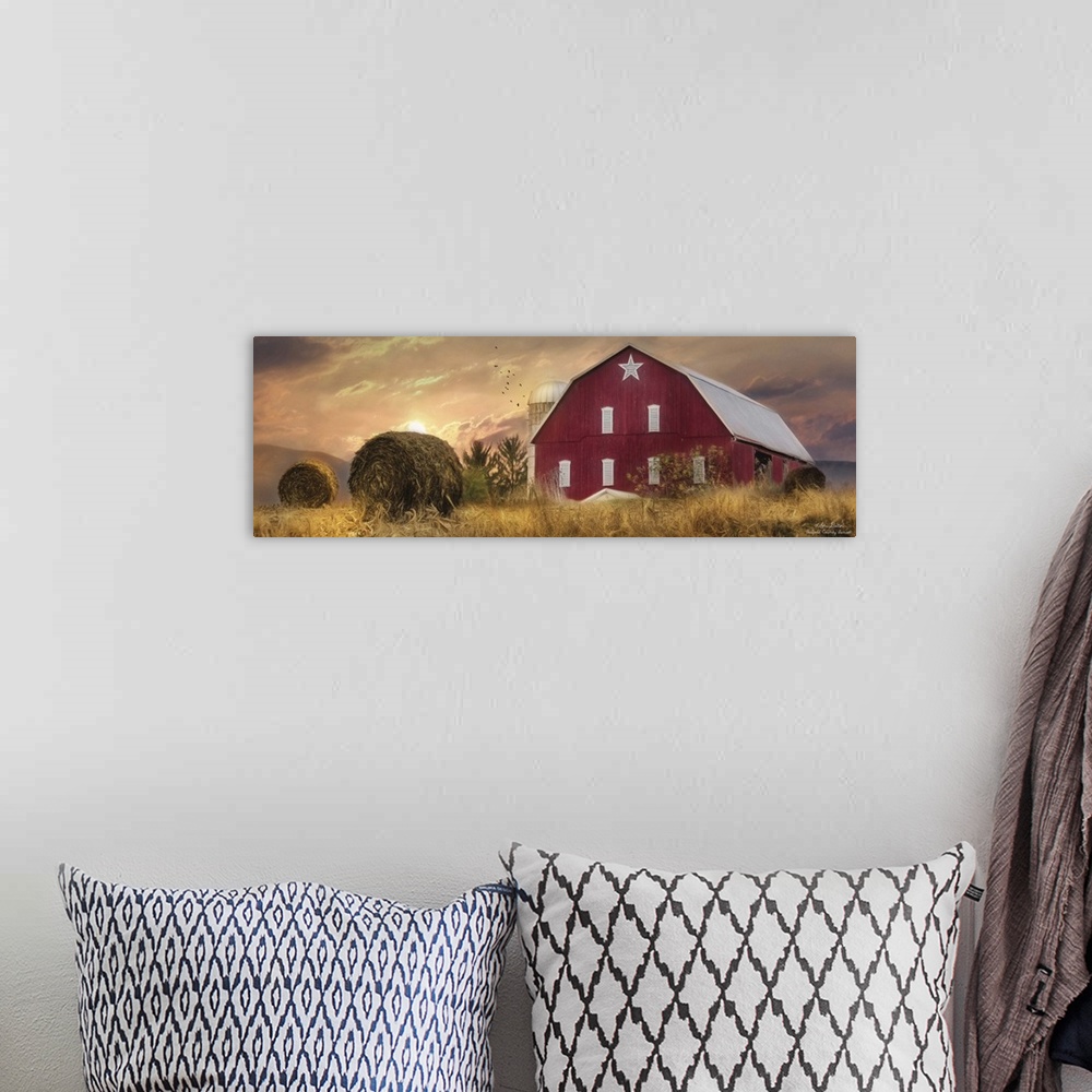 A bohemian room featuring A large red barn in the countryside at sunset.