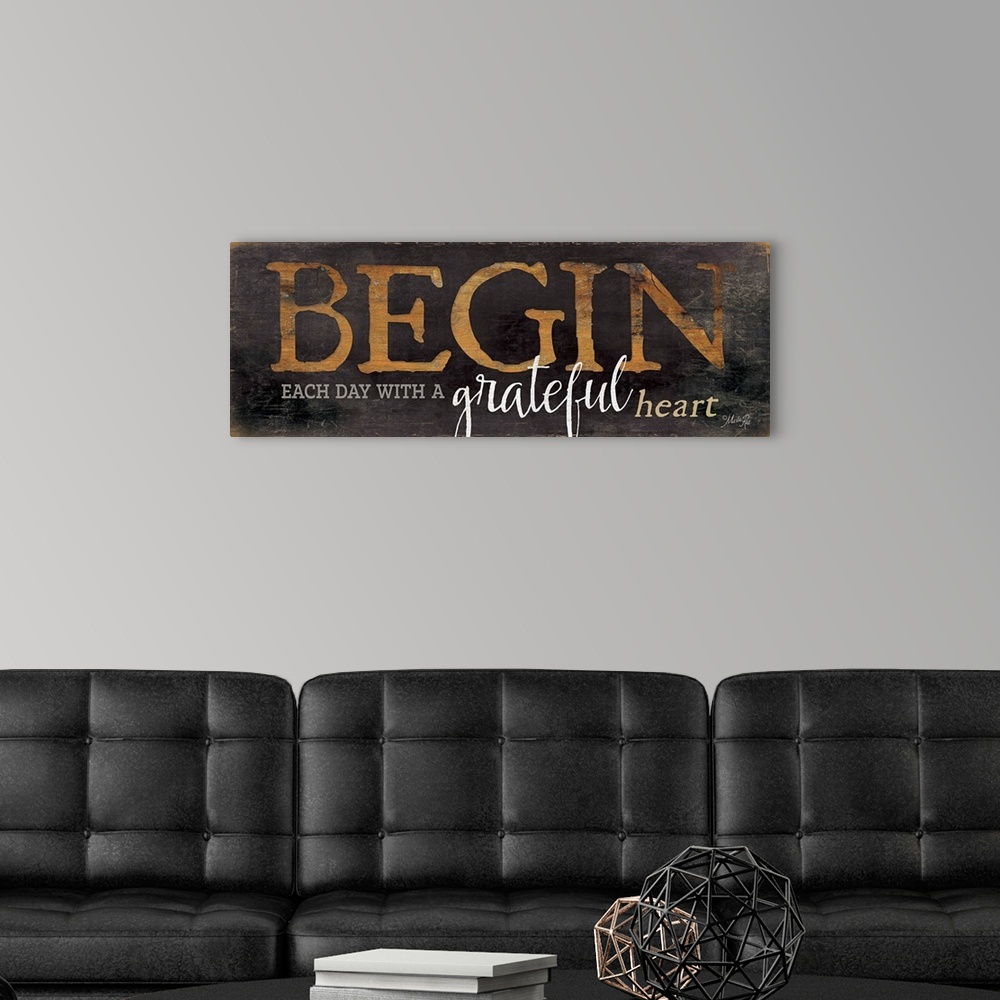 A modern room featuring Typography home decor art, with brown worn lettering against a dark weathered surface.