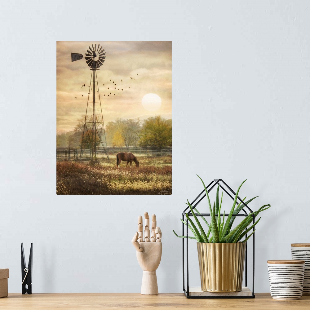 A bohemian room featuring Horse grazing in a field beside a windmill at sunrise.