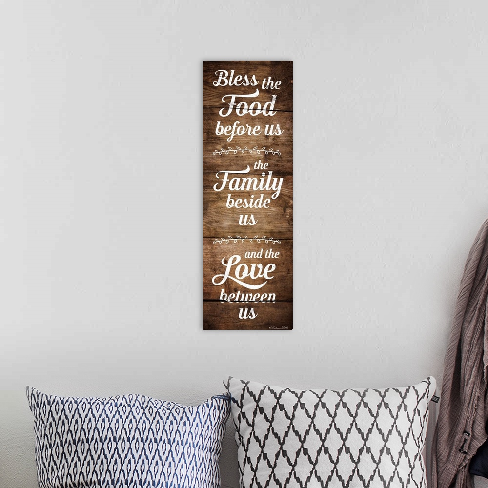 A bohemian room featuring Typography art in white script of a prayer honoring food, family, and love with a wooden board ba...
