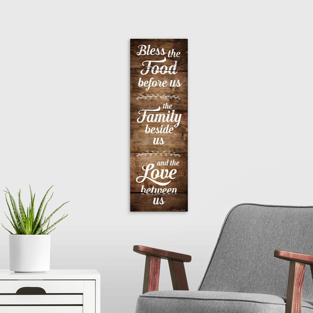 A modern room featuring Typography art in white script of a prayer honoring food, family, and love with a wooden board ba...